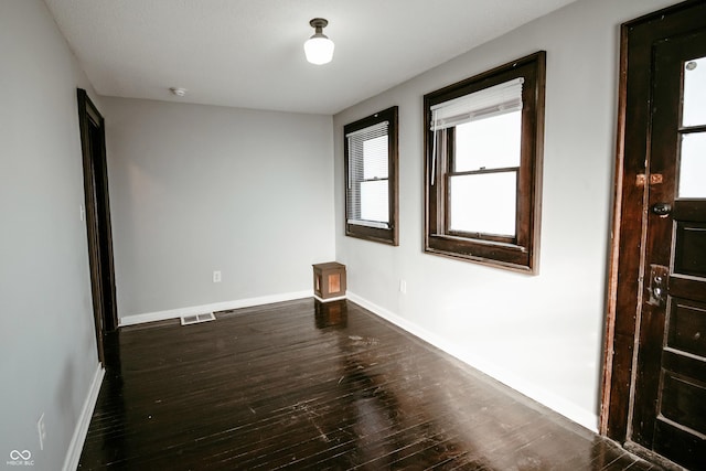 unfurnished room with hardwood / wood-style floors