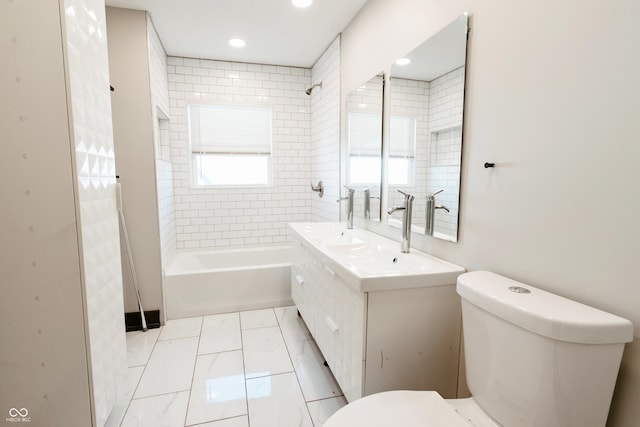 full bathroom featuring tiled shower / bath combo, vanity, and toilet