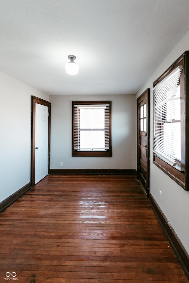 empty room featuring dark hardwood / wood-style floors