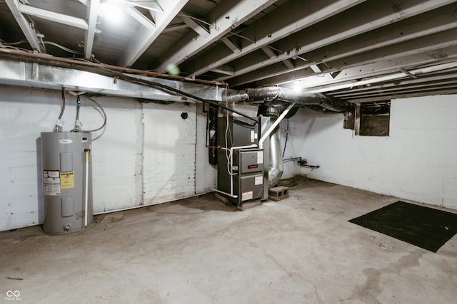 basement featuring heating unit and electric water heater