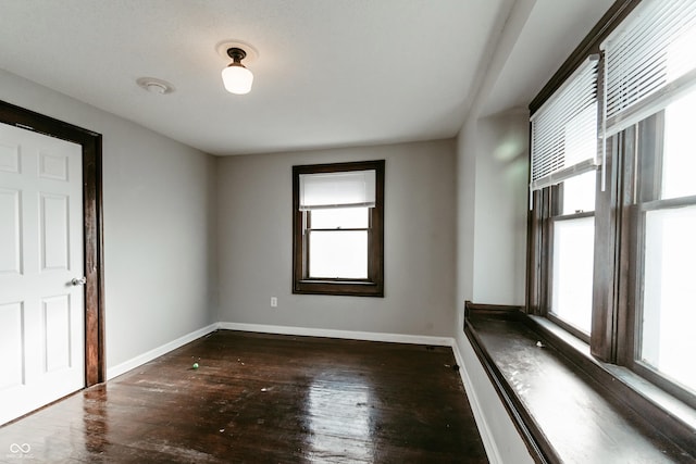 unfurnished room featuring dark hardwood / wood-style floors