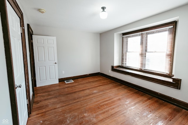 unfurnished bedroom with dark hardwood / wood-style flooring