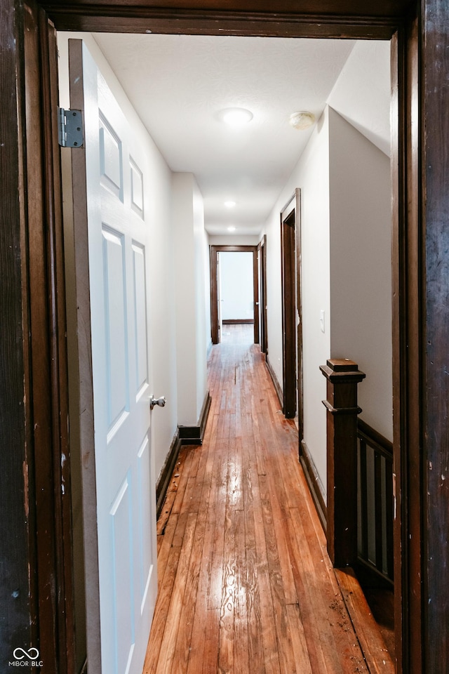 corridor with light hardwood / wood-style flooring