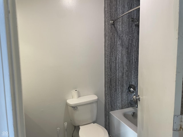 bathroom featuring bathing tub / shower combination and toilet