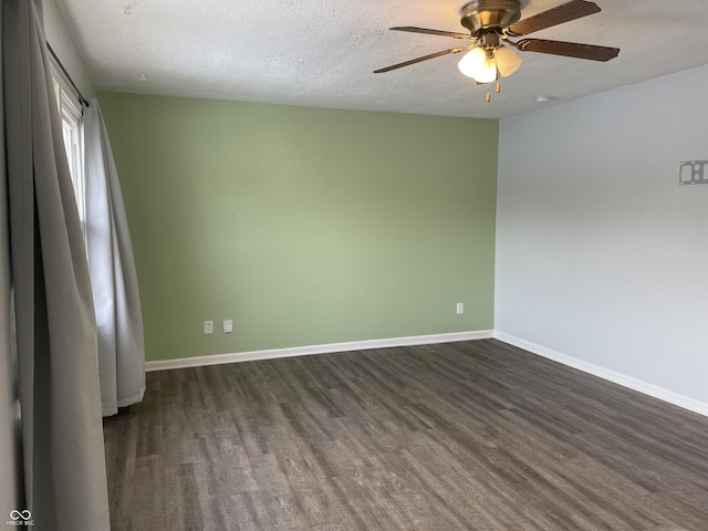 spare room with dark wood-type flooring, a textured ceiling, and ceiling fan