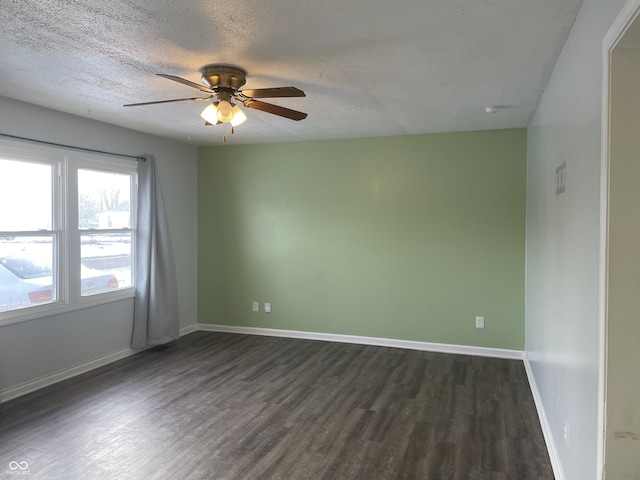 spare room featuring ceiling fan, dark hardwood / wood-style floors, and a textured ceiling