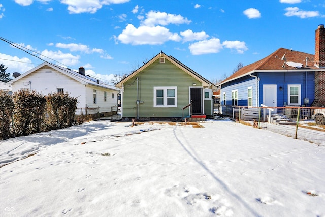 view of snow covered rear of property