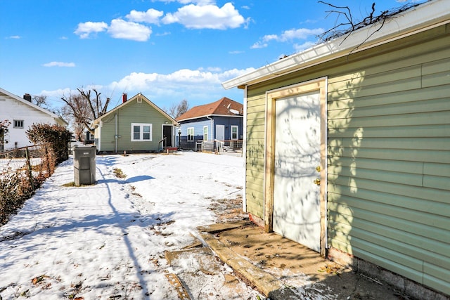 yard layered in snow with an outdoor structure