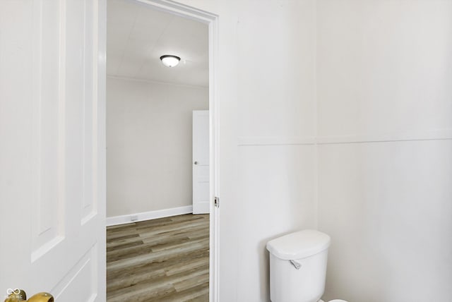 bathroom featuring wood-type flooring and toilet