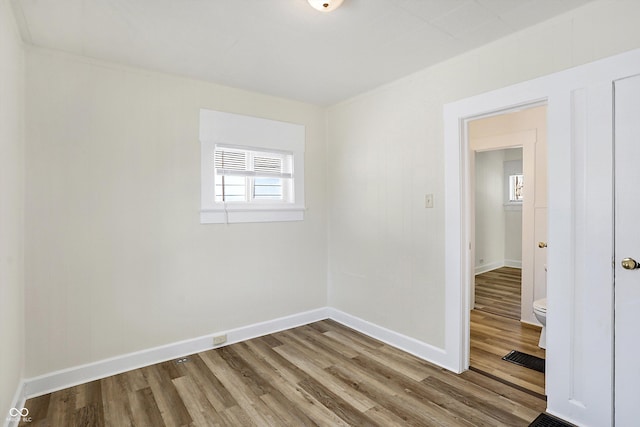 unfurnished room with hardwood / wood-style floors