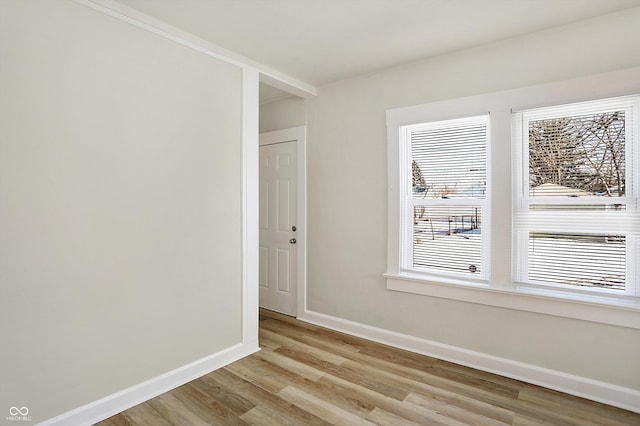 unfurnished room featuring light hardwood / wood-style flooring and a wealth of natural light