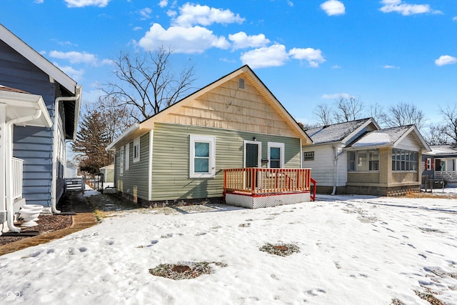 snow covered house with a deck