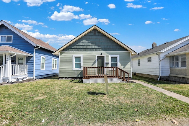 back of house with a lawn and a deck