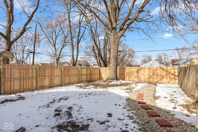 view of yard layered in snow