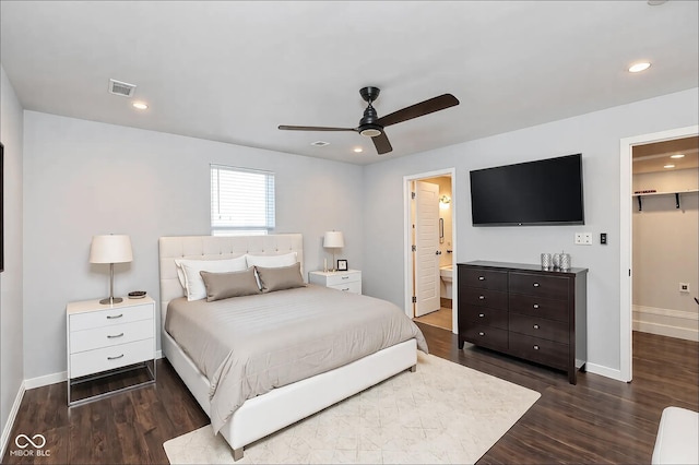 bedroom with a spacious closet, dark hardwood / wood-style flooring, a closet, ceiling fan, and ensuite bathroom