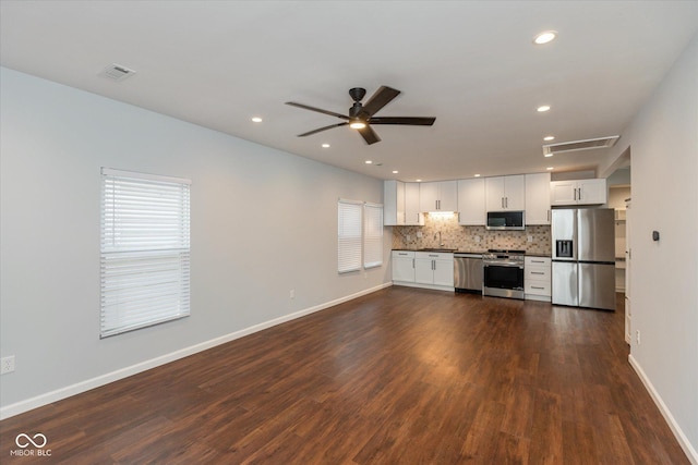 kitchen with sink, white cabinets, dark wood-type flooring, and appliances with stainless steel finishes