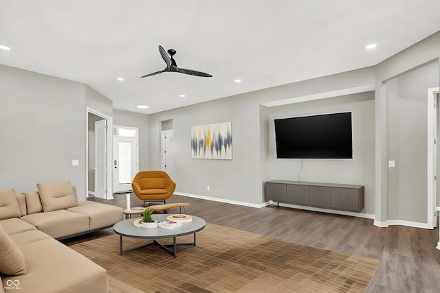 living room with wood-type flooring and ceiling fan