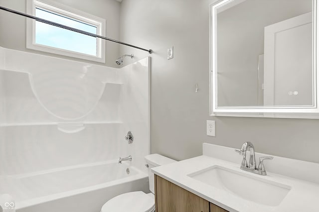 full bathroom featuring washtub / shower combination, vanity, and toilet