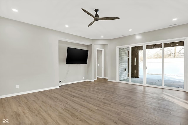 unfurnished living room featuring hardwood / wood-style floors and ceiling fan