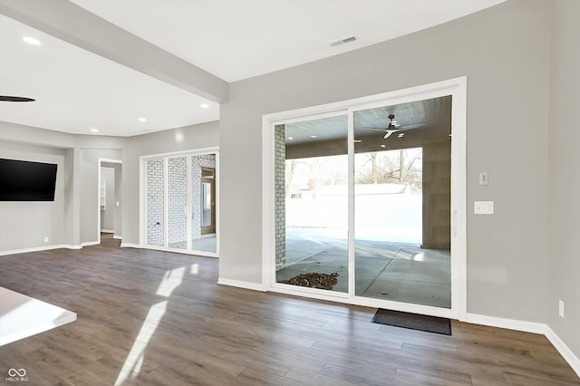 unfurnished living room with hardwood / wood-style flooring and ceiling fan