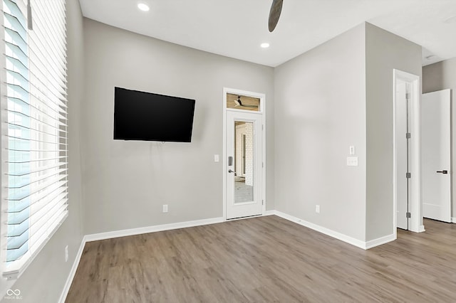 unfurnished room featuring hardwood / wood-style floors and ceiling fan