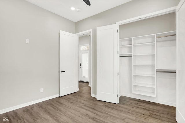 unfurnished bedroom with hardwood / wood-style flooring and a closet