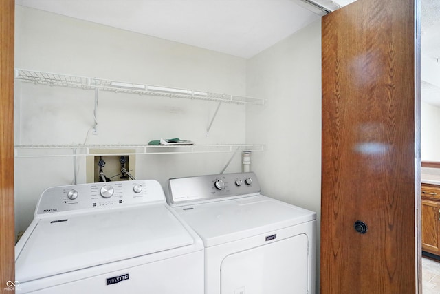 clothes washing area featuring washer and clothes dryer