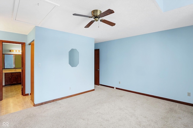 empty room with light colored carpet and ceiling fan