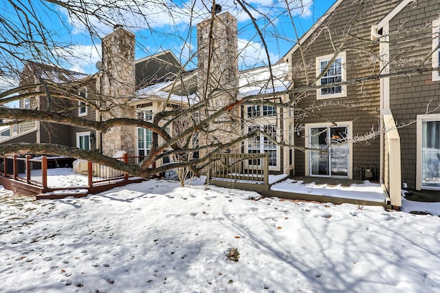 snow covered property featuring a deck