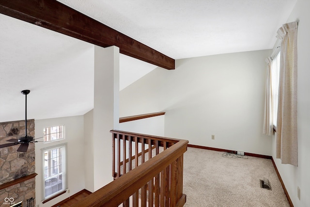 hallway featuring vaulted ceiling with beams and carpet flooring