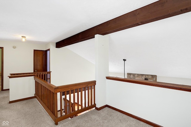 hallway with light colored carpet and lofted ceiling with beams