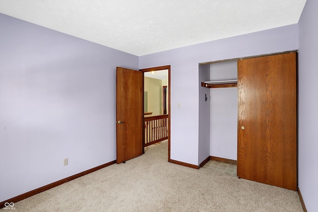 unfurnished bedroom featuring a closet and light colored carpet