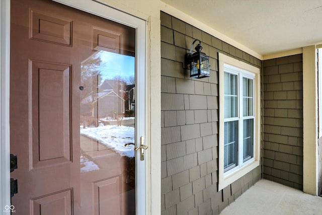 view of snow covered property entrance