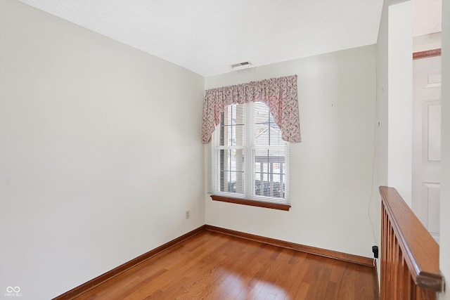 empty room with hardwood / wood-style floors