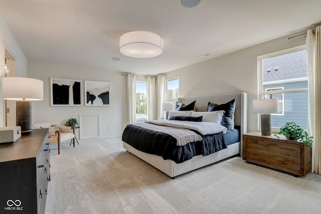 bedroom featuring light carpet