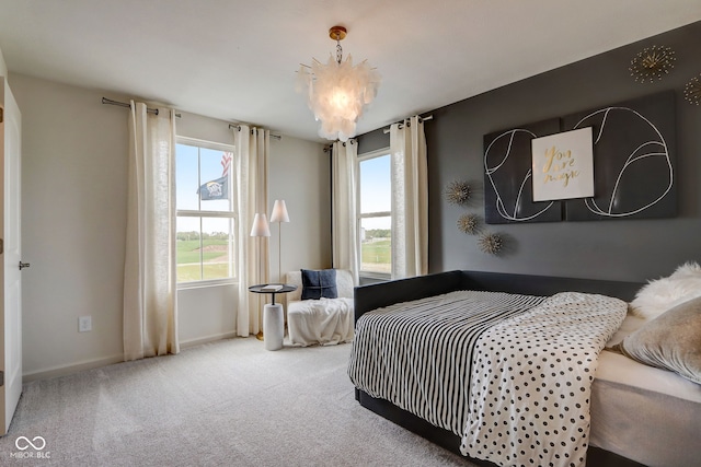 bedroom featuring carpet and an inviting chandelier