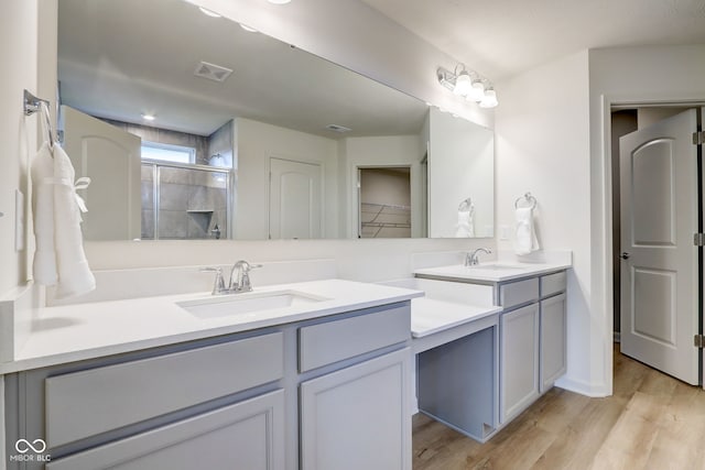 bathroom featuring vanity, walk in shower, and hardwood / wood-style floors