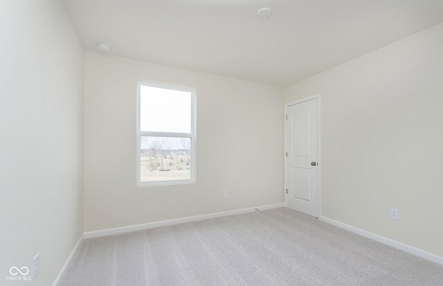 empty room with light carpet and baseboards