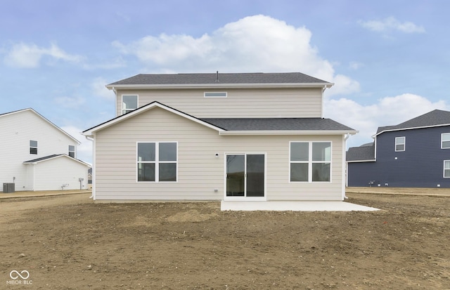 back of house with a patio area, cooling unit, and roof with shingles