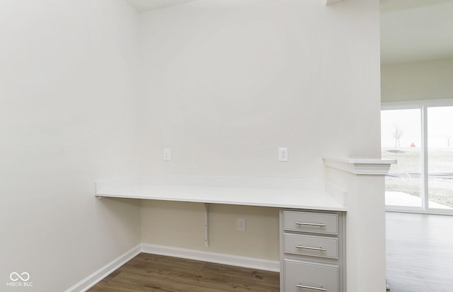 details with built in desk, wood finished floors, and baseboards