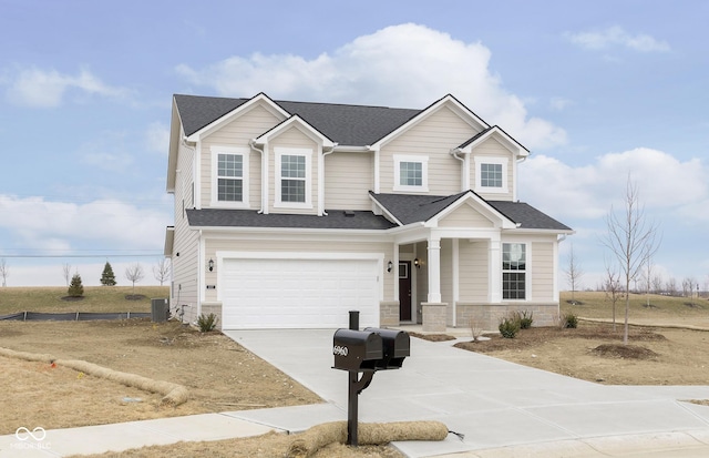 view of front facade with a shingled roof, concrete driveway, an attached garage, central AC unit, and stone siding