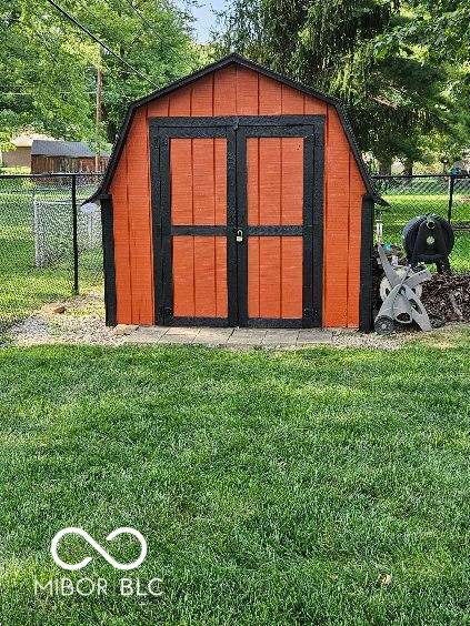 view of outbuilding with a lawn