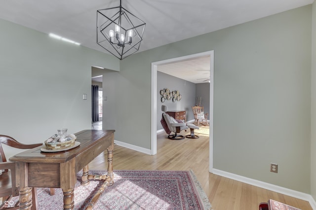 interior space featuring light hardwood / wood-style flooring and a notable chandelier