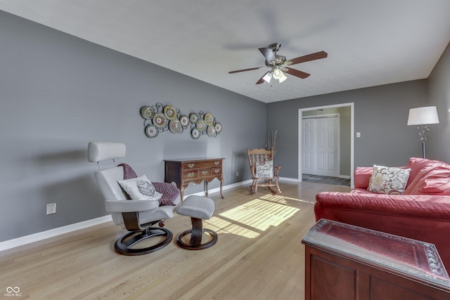 living area with ceiling fan and light hardwood / wood-style flooring