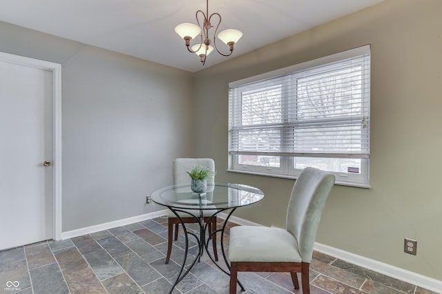 dining area featuring a notable chandelier