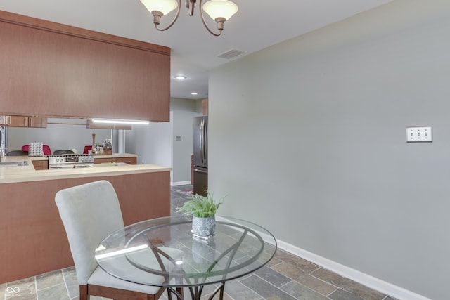 dining room with sink and an inviting chandelier