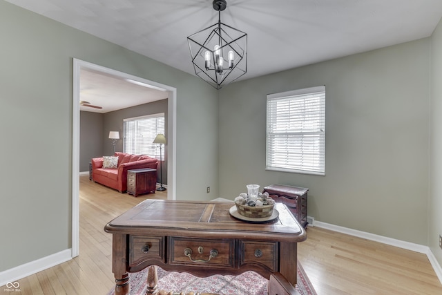 office area with a chandelier and light hardwood / wood-style flooring