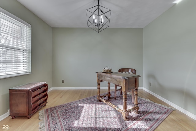 office space featuring light hardwood / wood-style floors and an inviting chandelier