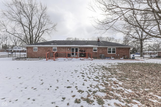 snow covered house with central AC