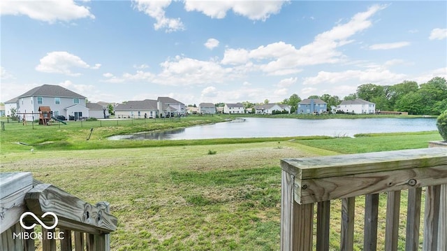 view of yard with a playground and a water view